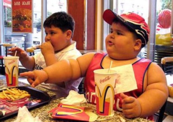a fat kid eating mc donalds
